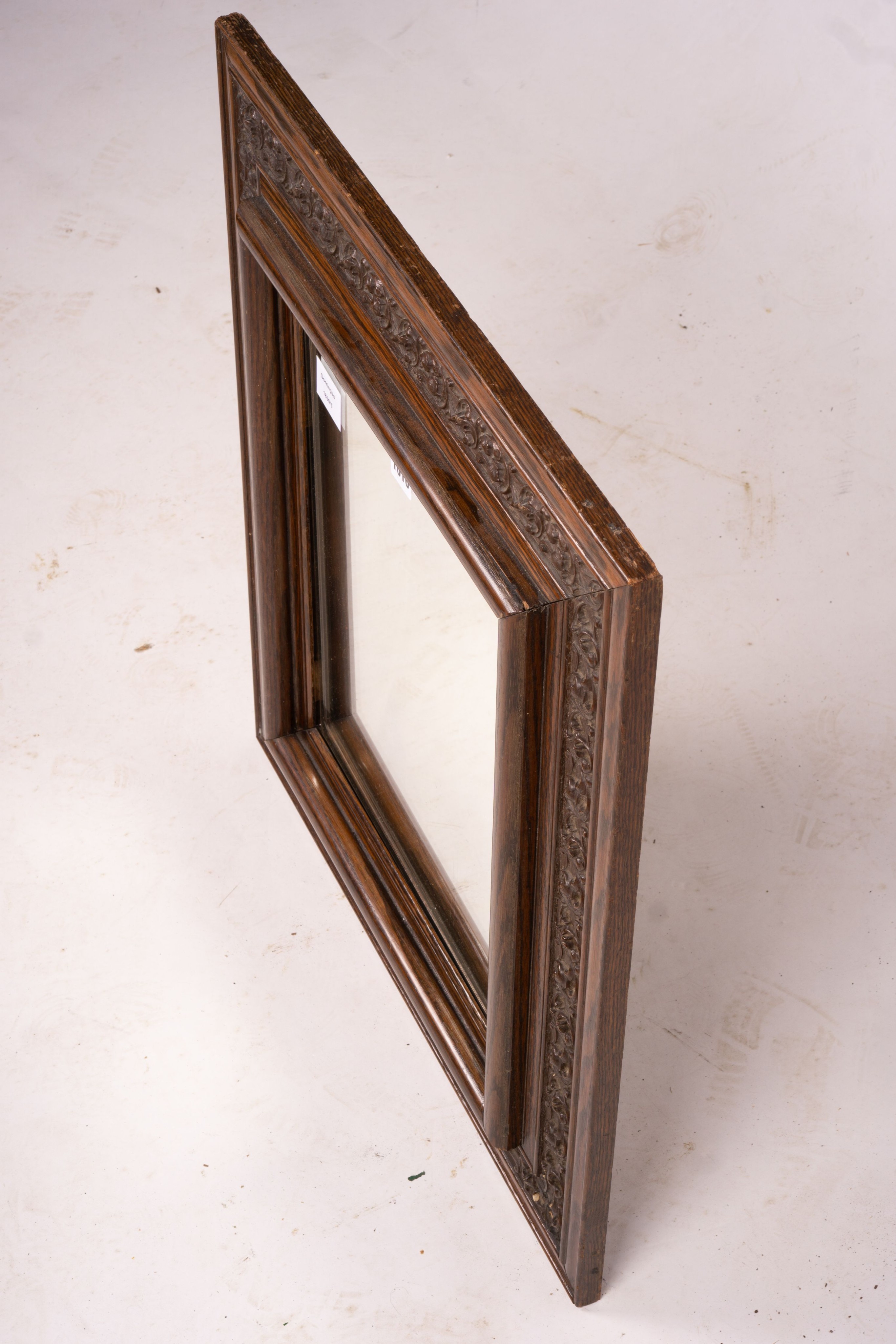 An early 20th century carved oak rectangular wall mirror, width 57cm, height 64cm